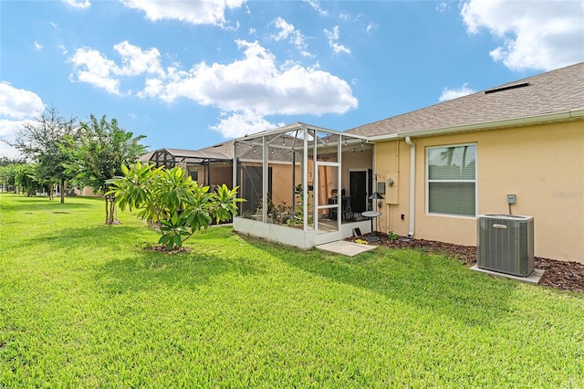 view of yard with a lanai and central AC