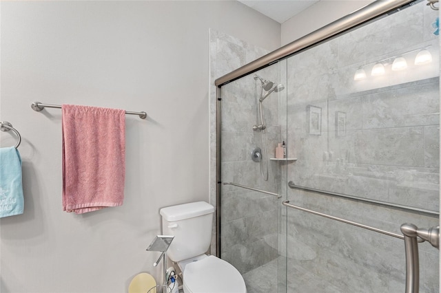 bathroom with toilet and an enclosed shower