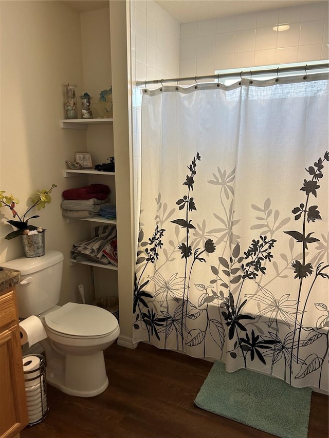 bathroom with vanity, curtained shower, hardwood / wood-style floors, and toilet