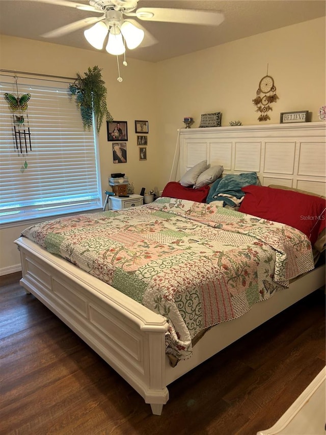 bedroom with dark hardwood / wood-style floors and ceiling fan