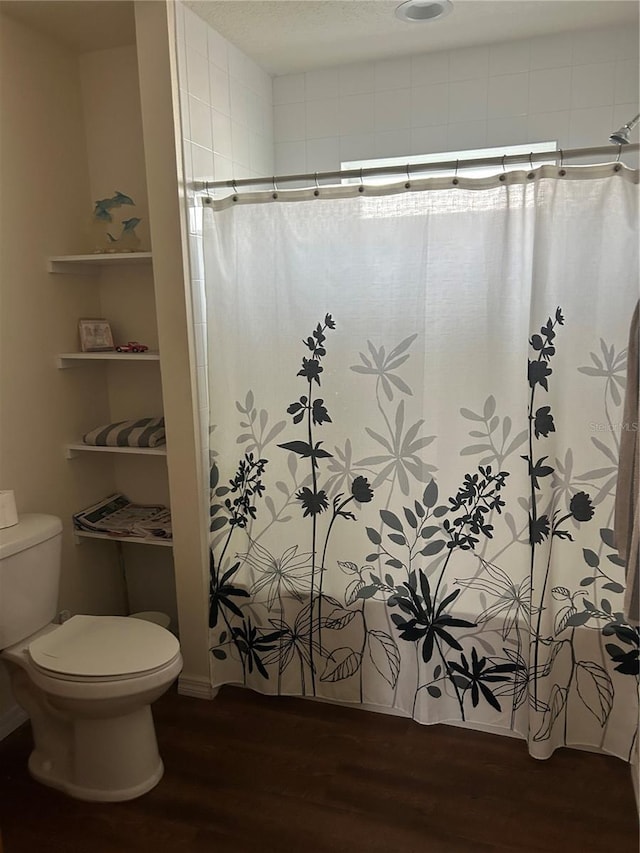 104 Turtle Run, Umatilla, FL 32784 - bathroom with wood finished floors, toilet, and a shower with shower curtain