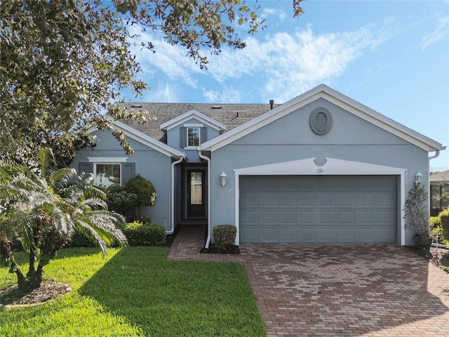 view of front of home featuring a garage and a front lawn