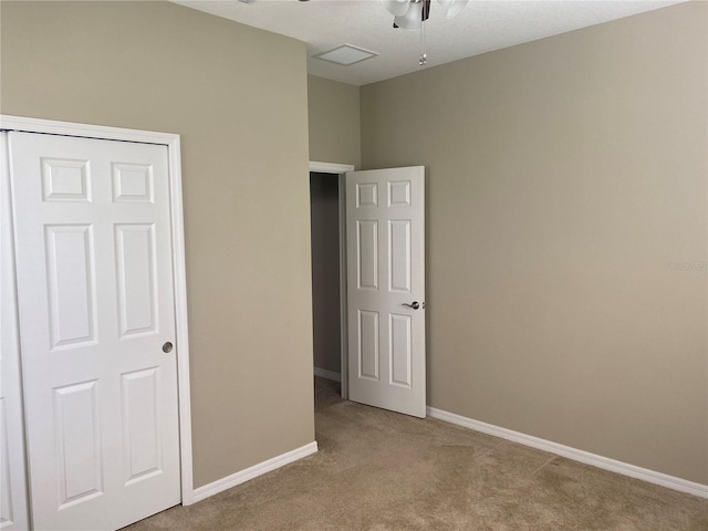 unfurnished bedroom with a closet and light colored carpet