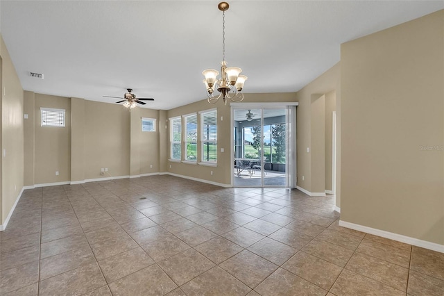 spare room featuring ceiling fan with notable chandelier and light tile patterned floors