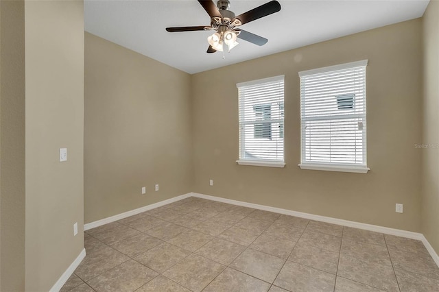 tiled spare room featuring ceiling fan