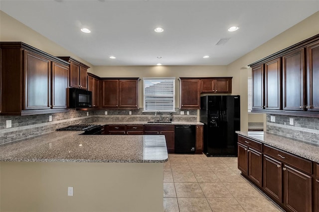 kitchen featuring black appliances, dark brown cabinetry, light tile patterned floors, and light stone countertops