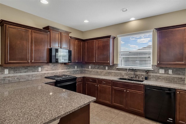 kitchen with light stone counters, black appliances, decorative backsplash, sink, and light tile patterned flooring