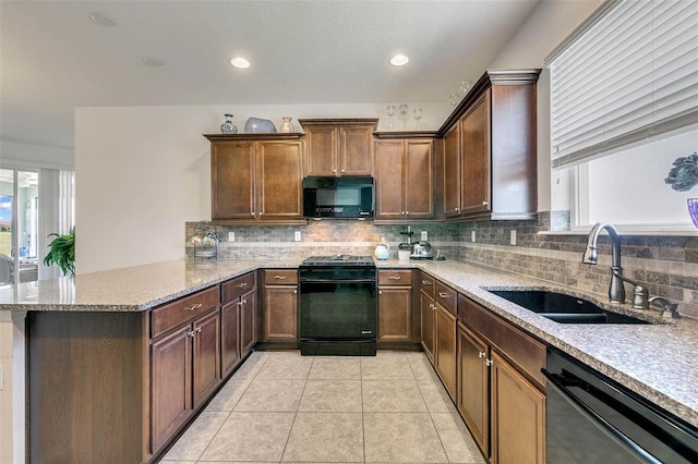 kitchen with tasteful backsplash, sink, kitchen peninsula, black appliances, and light tile patterned floors