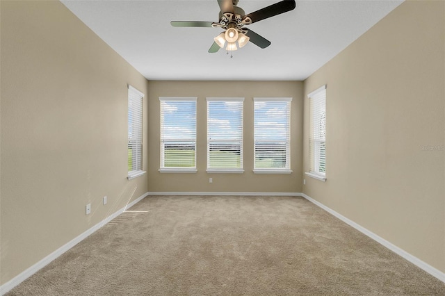 carpeted spare room with ceiling fan