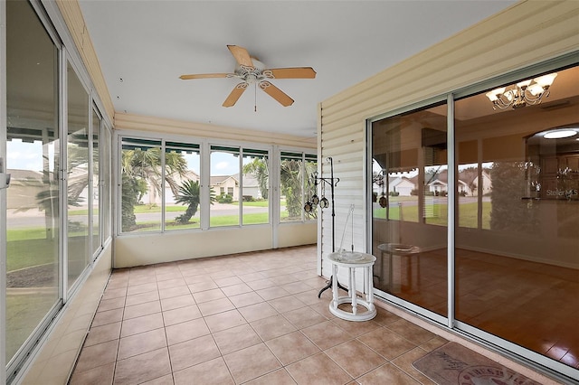 unfurnished sunroom featuring ceiling fan