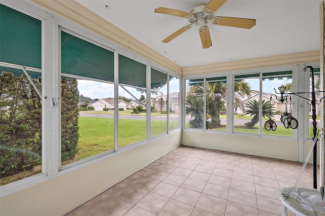 unfurnished sunroom with a healthy amount of sunlight and ceiling fan