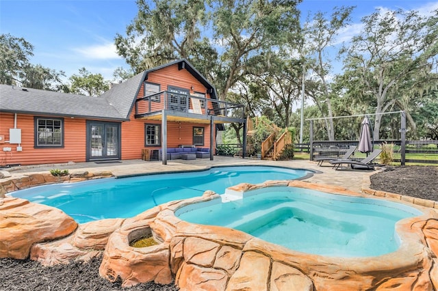 view of pool featuring a patio and an in ground hot tub