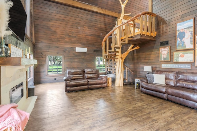 living room featuring wood-type flooring, beam ceiling, a fireplace, high vaulted ceiling, and wooden walls