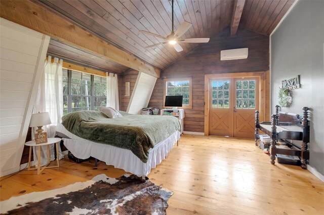 bedroom featuring light wood-type flooring, vaulted ceiling with beams, wood walls, and ceiling fan