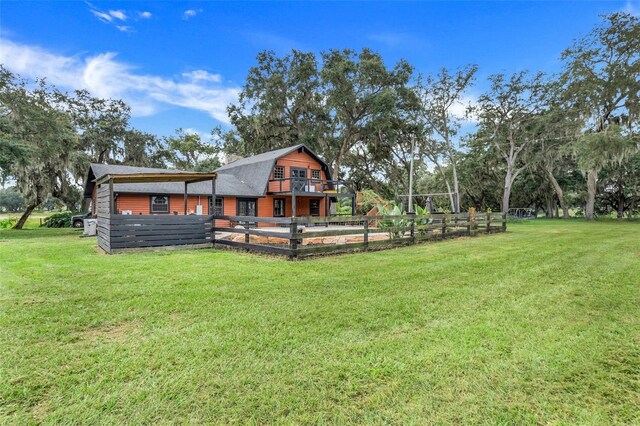 back of property with a yard and a wooden deck