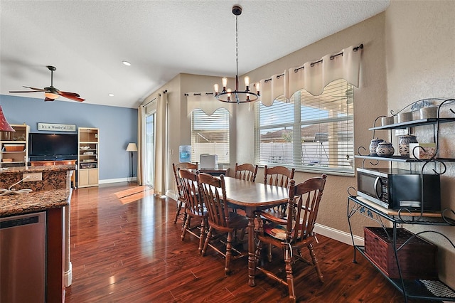 dining space with ceiling fan with notable chandelier, a textured ceiling, lofted ceiling, and dark hardwood / wood-style flooring