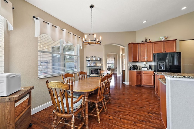 dining space with an inviting chandelier and dark wood-type flooring