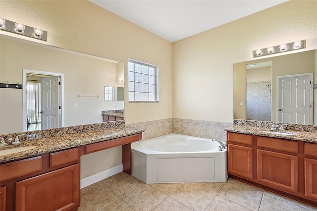 bathroom featuring independent shower and bath, vanity, and tile patterned flooring