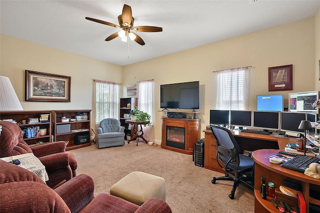 carpeted home office featuring ceiling fan and plenty of natural light