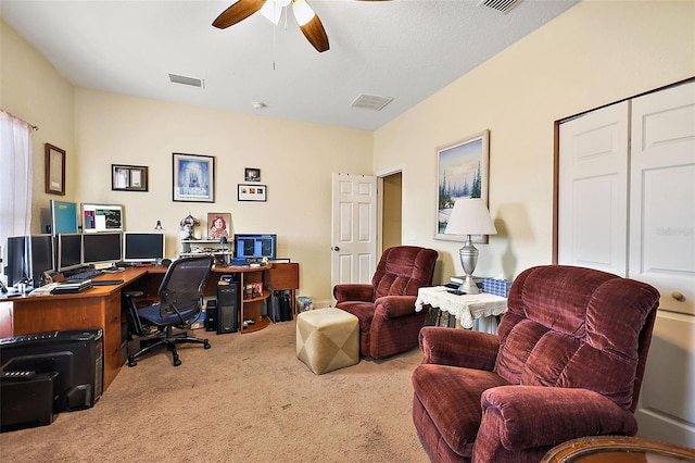 office area featuring light carpet and ceiling fan