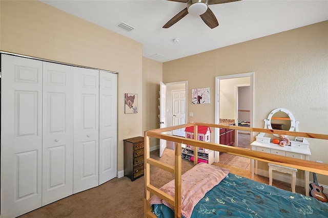 carpeted bedroom featuring ceiling fan and a closet