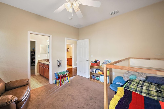 bedroom featuring ensuite bath, ceiling fan, and light colored carpet