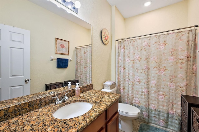 bathroom with walk in shower, vanity, toilet, and tile patterned floors