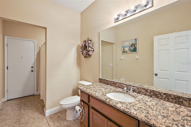 bathroom with vanity, toilet, and tile patterned floors