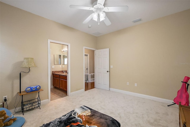 living area with ceiling fan, sink, and light colored carpet