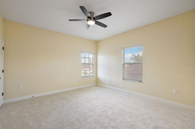 unfurnished room featuring light colored carpet and ceiling fan