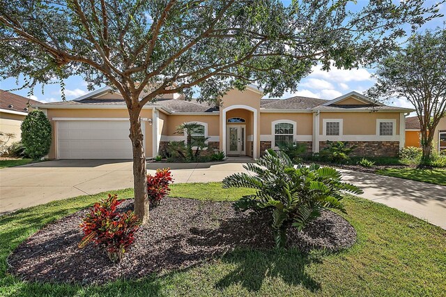 view of front facade featuring a front lawn and a garage