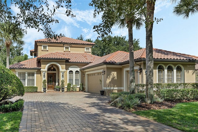 mediterranean / spanish-style home with a garage