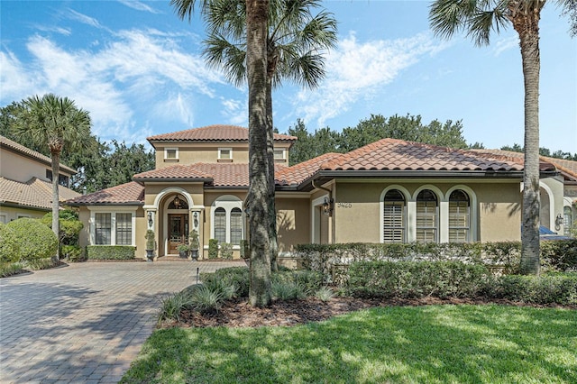 mediterranean / spanish-style home featuring a front lawn