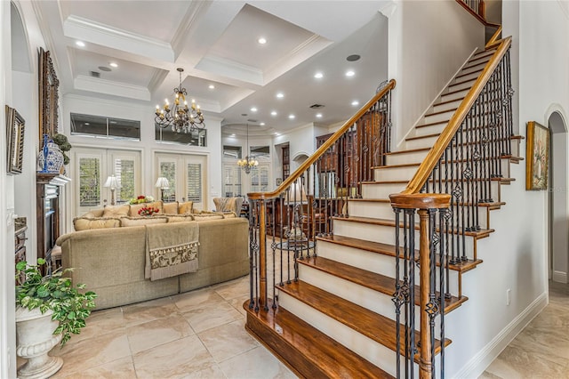 staircase with beamed ceiling, a notable chandelier, coffered ceiling, ornamental molding, and a high ceiling