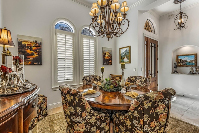 dining room featuring ornamental molding, a chandelier, and light tile patterned flooring