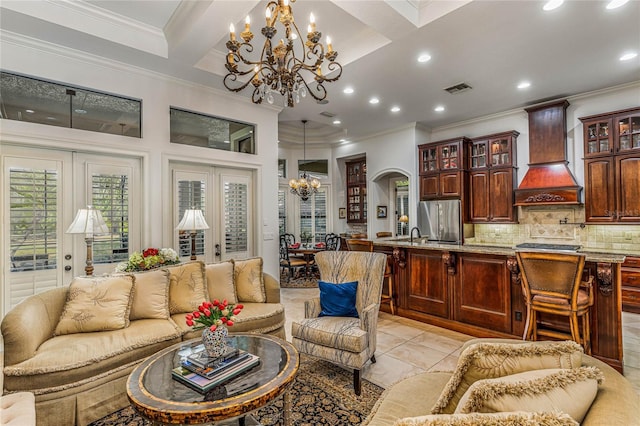 tiled living room featuring crown molding, beam ceiling, and an inviting chandelier