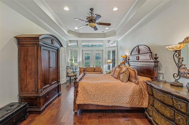 bedroom featuring ceiling fan, a raised ceiling, french doors, dark wood-type flooring, and crown molding