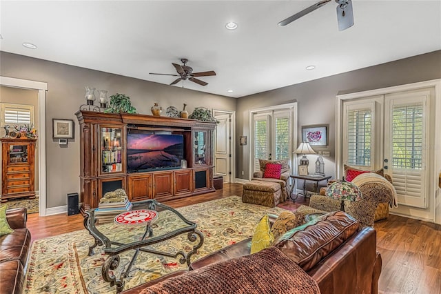 living room with a healthy amount of sunlight, hardwood / wood-style floors, ceiling fan, and french doors