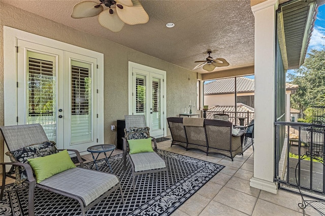 view of patio with ceiling fan, an outdoor living space, and french doors