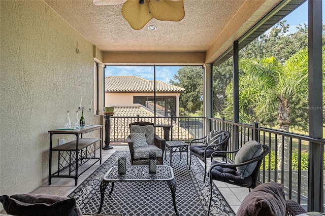 sunroom featuring ceiling fan