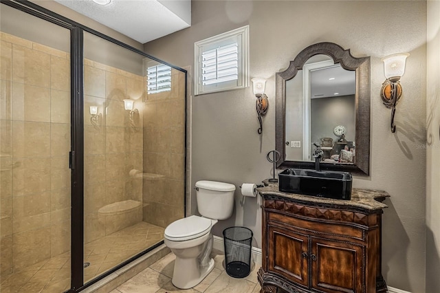 bathroom with vanity, toilet, tile patterned floors, and a shower with shower door