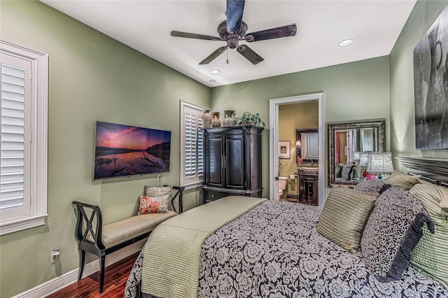 bedroom with ceiling fan, ensuite bathroom, and dark wood-type flooring