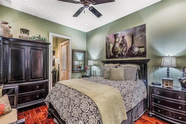 bedroom with dark hardwood / wood-style flooring and ceiling fan