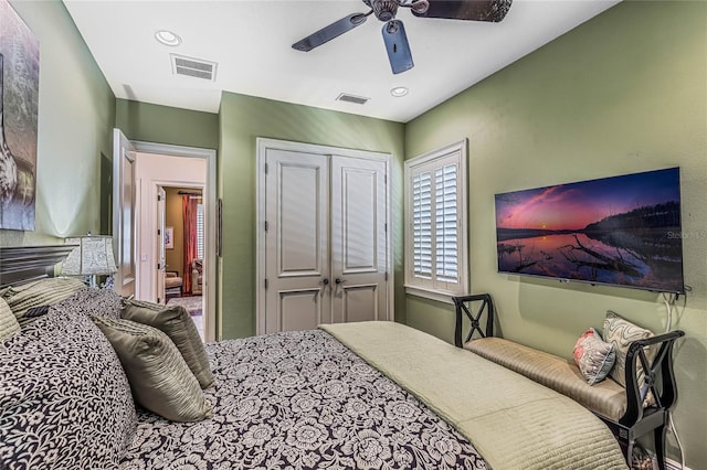 bedroom with ceiling fan and a closet