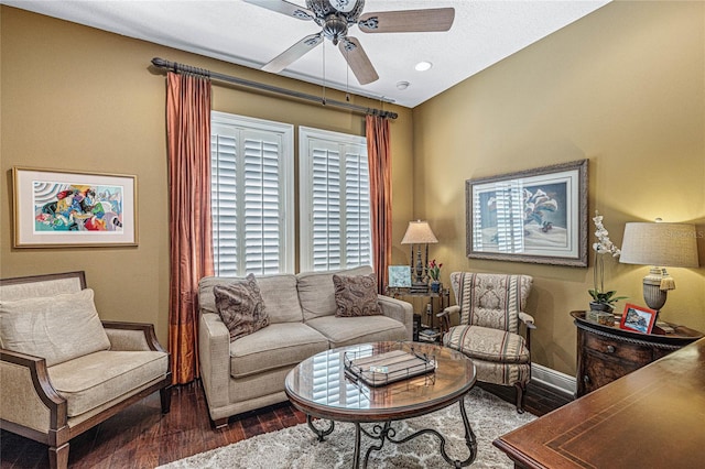 living room with dark hardwood / wood-style flooring and ceiling fan