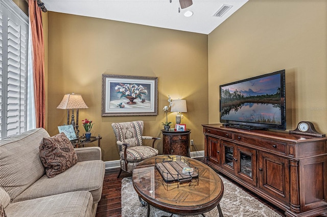 living room featuring ceiling fan, dark hardwood / wood-style floors, and a wealth of natural light