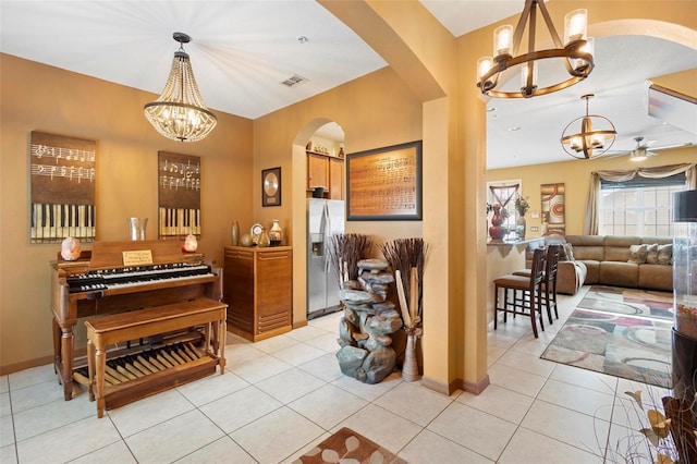 interior space with ceiling fan and light tile patterned flooring