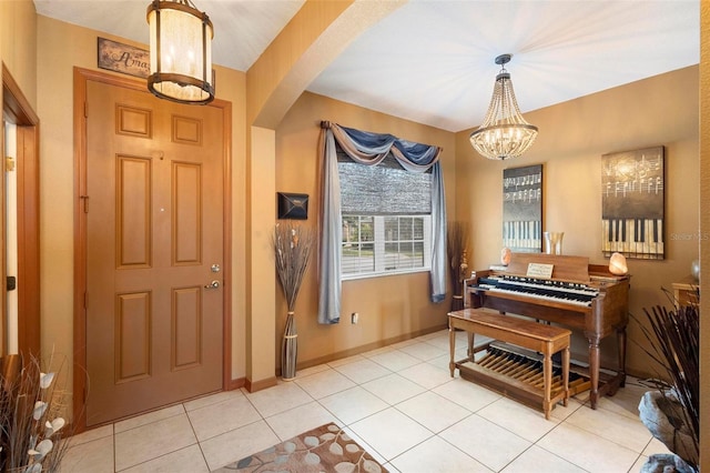 tiled foyer entrance featuring a notable chandelier