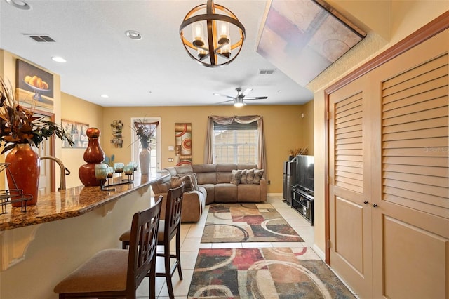 living room with light tile patterned floors and ceiling fan