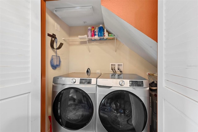 laundry area with washing machine and clothes dryer